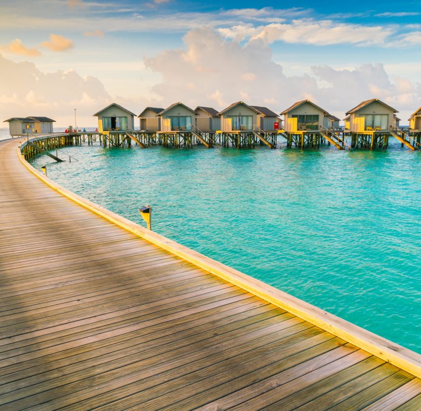Beautiful water villas in tropical Maldives island at the sunrise time